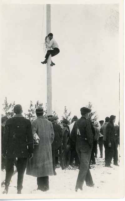 Student climbing flag pole