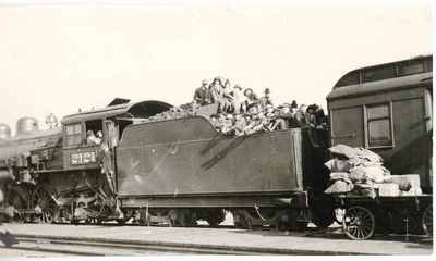Students sitting in a railroad car loaded with coal, 1920