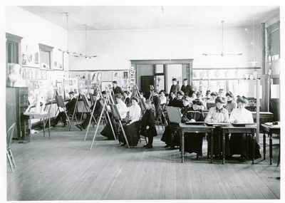 Class of art students sketching a statue