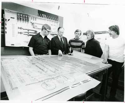 Student reviewing drawings with teacher, 1980