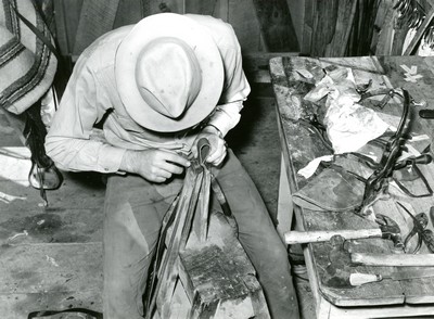 Cowhand Working with Leather, Quarter Circle U Ranch, Big Horn County, MT