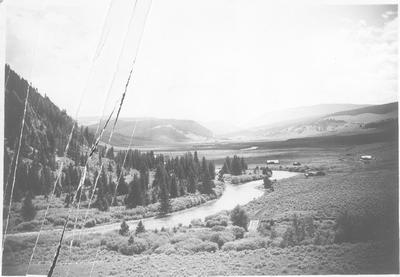 Gallatin River with road across bridge & valley with scattered buildings