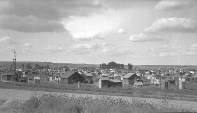 Town on the prairie, wooden houses & outbuildings (near Fort Peck Dam during construction)