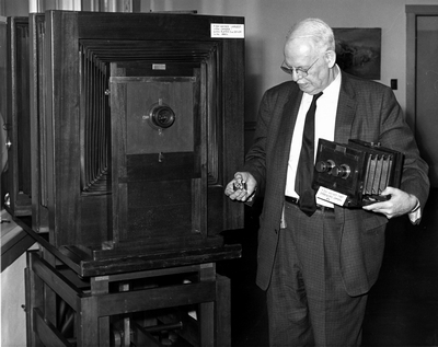 Jack E. Haynes showing F. Jay Haynes original cameras