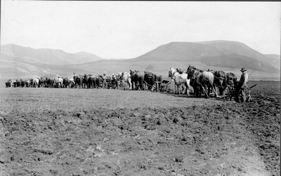 Farmers preparing field for planting in Montana
