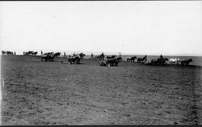 Farmers preparing field for planting in Montana