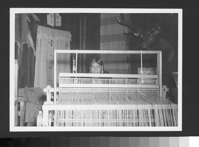 An Arapaho Woman Working on Looms Weaving