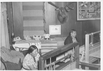 Two Arapaho Women Weaving on Floor Looms