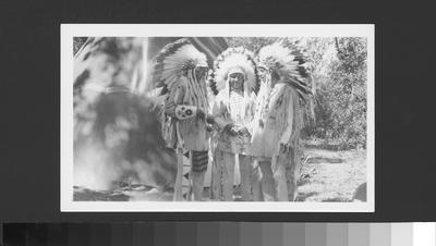 Bernadotte: Blackfeet Indians: Three Men in Full Indian Dress Stand Together In Front of Tipi, 1939