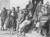 Large Group of Indian Men and Women Dressed Warmly Gathered Around Steps, Browning, Montana