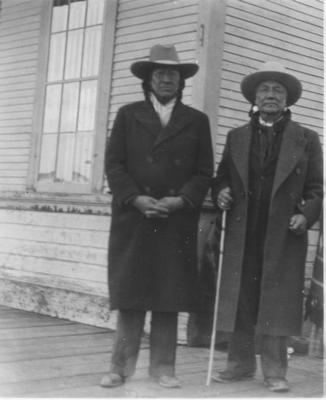 Black and white photo of Eddie Big Beaver and Yellow Kidney posing for a photo in Browning, Montana, 1938