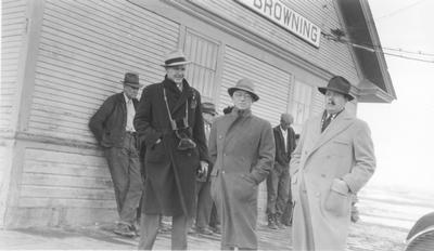 Black and white photo of Technicians standing outside the Browning, Montana train depot.