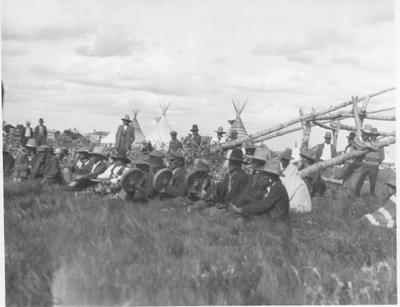 Black and white photo of a large group of people watching and event, part of the Sun Lodge Ceremonies, Browning, Montana, 1927