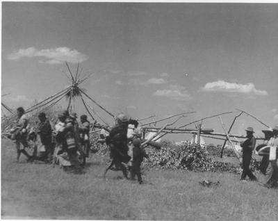 Black and white photo of a group of people heading to an event during the Sun Lodge Ceremonies, 1927