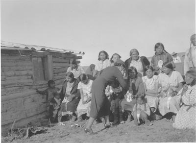 Black and white photo of a group of women getting ready for a group photo.