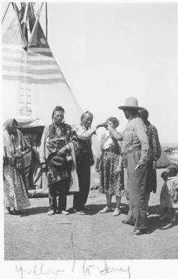 Black and white photo of Yellow Kidney greeting his friends.