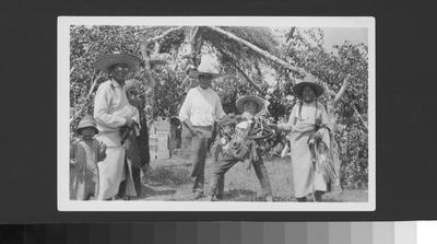 Black and white photo of a group of people with a scarecrow, during the Horn Society Sun Lodge ceremonies, 1927