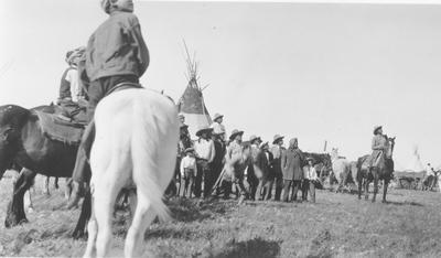 Black and white photo of a group of people watching arrows shot into the air during the Sun Lodge ceremonies, 1927
