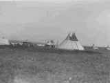 Black and white photo of a tipi and tent camp, Belly River, Alberta, 1927