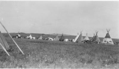 Black and white photo of a camp of tipis, 1927