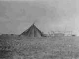 Black and white photo of three women standing next to The Rabbit Lodge, Alberta, Canada