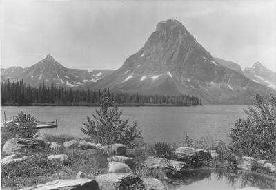 Black and white photo of Two Medicine Lake with a rock garden in the foreground in Glacier National Park, Montana