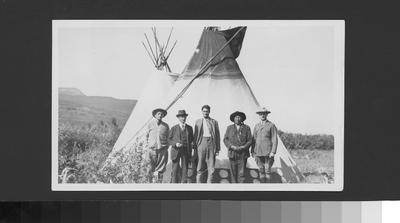 Photo of Eli Guardipee and friends standing in front of a tipi