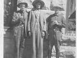 Photo of Eli Guardipee and friends standing in front of a stone wall.