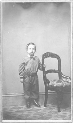 Portrait of James Willard Schultz As a Young Boy Next to a Chair