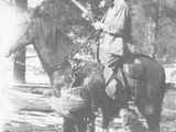 Man Riding a Horse While Turkey Hunting with His Dog