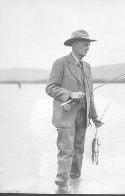 An Older Man Holding a Fly Rod and 3 Fish