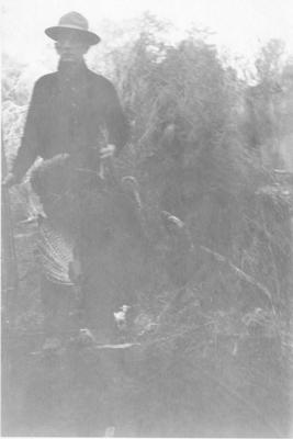 Man Holding a Shotgun Displays the Two Turkeys He Shot
