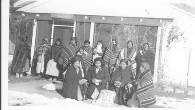 Group of Women Wrapped in Blankets Standing in Front of the