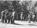 Photo of eight men, including Torrey Roberts, Pitsua Taylor, Steve Tappay, Hugo Brotsu and Ben Piney,  arranged in three rows during a ceremony.