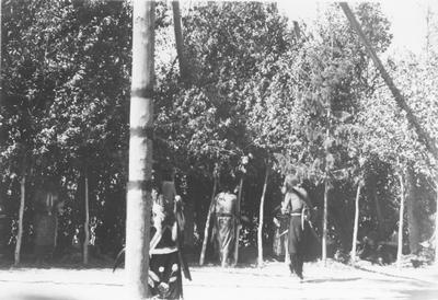 Indian Men Walking Away From a Painted Pole with Stripes