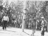 Man and Woman Stand in Front of Center Pole of the Lodge During a Ceremony