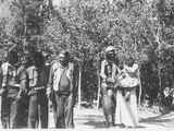 Photo of a group of people including, Hugo Bonalsie, Steve Tappay, Carlos Corinjo and Morgan Moon, walking across a clearing in the woods.