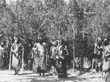 Photo of a group of men including, Frank Pogue, John LeClair, Andrew McAdams, Logan Brown, John Brown, Harry Bonatsie, in ceremonial dress