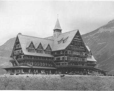 Waterton Lakes National Park: A Group of Several Men Stand Outside of the Prince of Wales Hotel